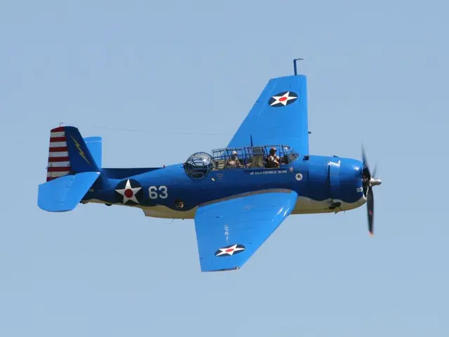 In the image there is a blue color airplane flying in the air and behind its sky.