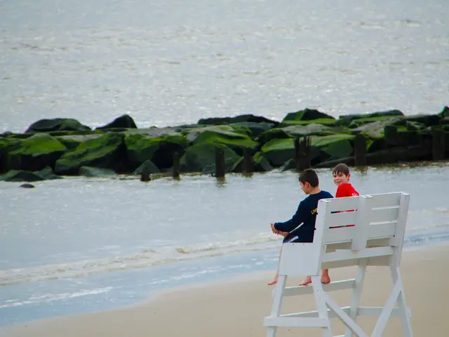 On the right side kids are sitting on the bench chair. This is water in the middle there are...